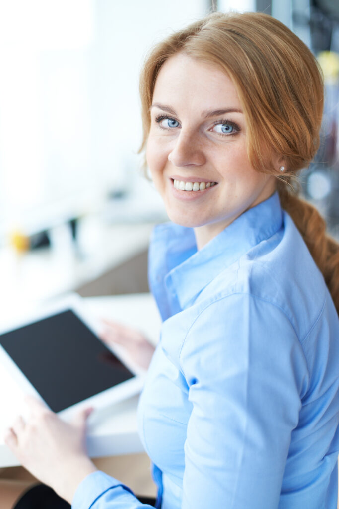 Portrait of pretty businesswoman or student looking at camera with smile